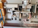 an image of a machine that is working on a piece of metal