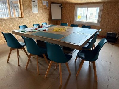 a table and chairs in a room with a wallpapered wall
