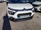 the front of a white citrole parked in a parking lot