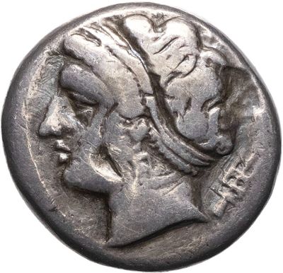 a silver coin with a woman ' s head on it