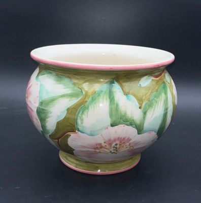 a vase with a flower design on it on a black background