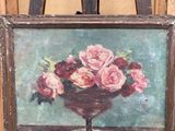 un tableau représentant des roses dans un vase posé sur un chevalet