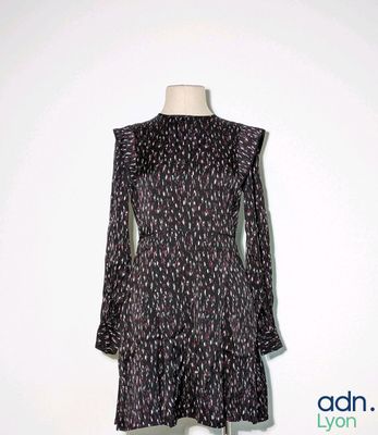 a black and white dress on a mannequin stand
