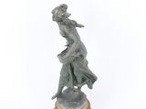 bronze statue of a woman on a pedestal on a white background