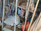 a ladder that is next to a pile of junk