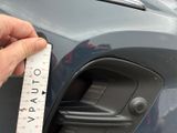 someone is measuring the height of the front bumper of a car