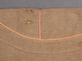 the back of a brown shirt with a small hole in it