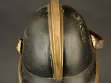 an old helmet on a stand with a black background
