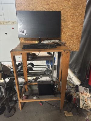a computer sitting on top of a wooden stand
