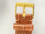 a brown leather watch strap with a gold buckle