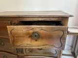 a wooden dresser with a drawer on top of it