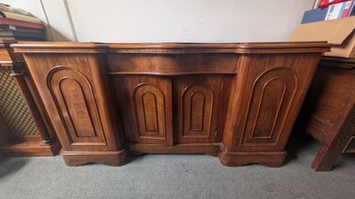 a close up of a wooden desk with two doors on top of it