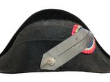 a black hat with a red, white, and blue ribbon on it