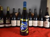 several bottles of wine are lined up on a table