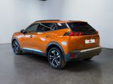 the rear end of an orange nissan suv parked in a showroom