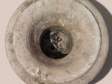 a stone vase with a hole in the middle of it