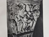 an old black and white photo of a column with animals on it