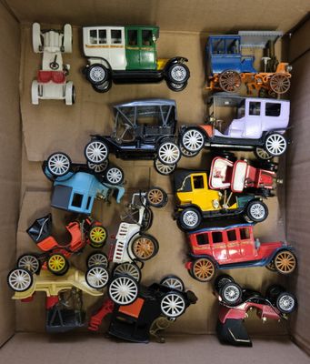 a cardboard box filled with various toy cars and trucks