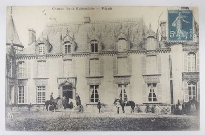 a black and white photo of a building with horses outside