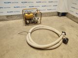 a hose that is laying on the ground next to a machine