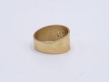 a close up of a gold ring on a white surface