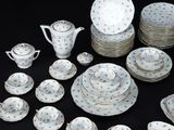 many plates and cups and saucers on the table