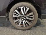 a close up of a tire on a car in a garage
