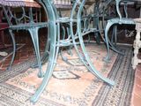a table and chairs in a room with a rug on the floor