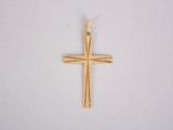a close up of a gold cross on a white surface