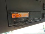 a car dashboard with a digital clock on it