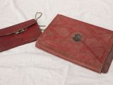 pair of red leather wallets on a white background
