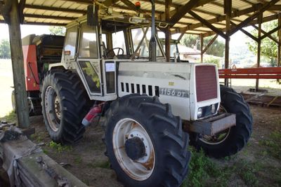 a tractor that is parked under a shelter