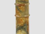 a tall wooden pedestal with a marbled top