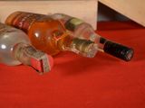 three bottles of alcohol sitting on a table next to a wooden box