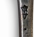 a silver spoon with a star on it on a white surface