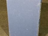 a blue book sitting on top of a brown carpet covered floor
