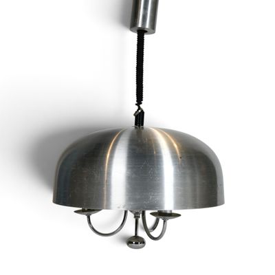 a metal light that is hanging from a wall