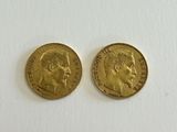 two gold sovereigns, one with the head of a man and the other of a woman