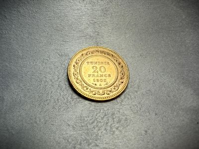 a close up of a gold coin on a table