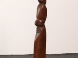 an image of a wooden sculpture of a woman standing on a pedestal