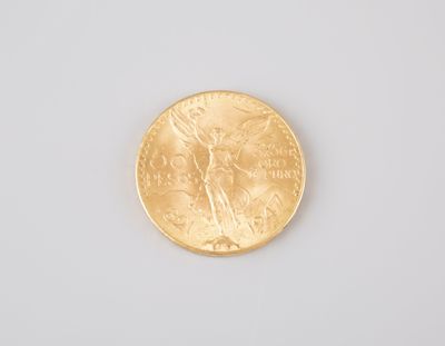 a close up of a gold coin on a white surface