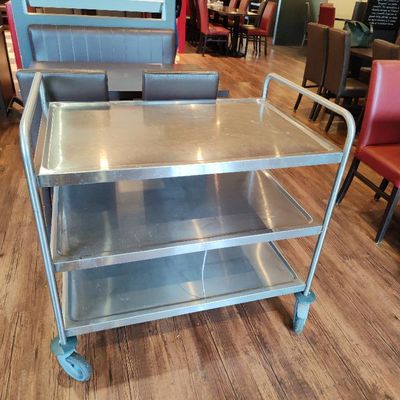 a metal cart that is sitting on a wooden floor