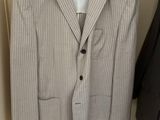 a suit hanging on a hanger in a closet