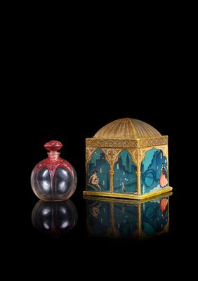 an image of a small glass bottle with a lid and a small glass container with a painting on it