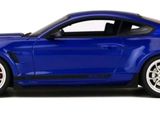 the blue mustang is parked on a white surface