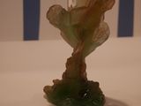 a glass vase with a flower in it sitting on a table