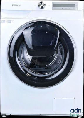 a close up of a white washing machine with a black knob