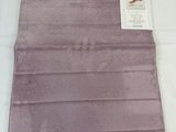 a close up of a purple towel on a white surface