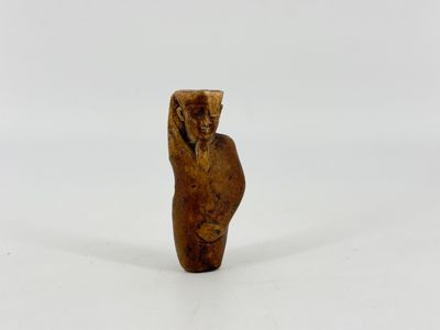 a small wooden figurine of a man with a hat on his head