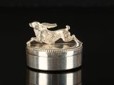 an image of a silver ring with a dog on top of it